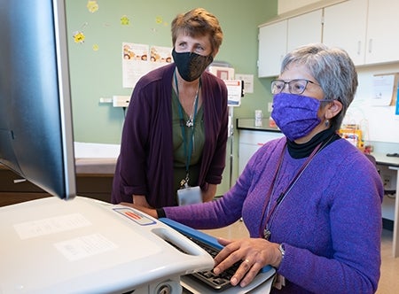 Katy Carlsen, left, with Albina Gogo, at the CIRCLE Clinic