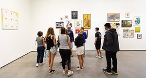 Crowd of people viewing artworks