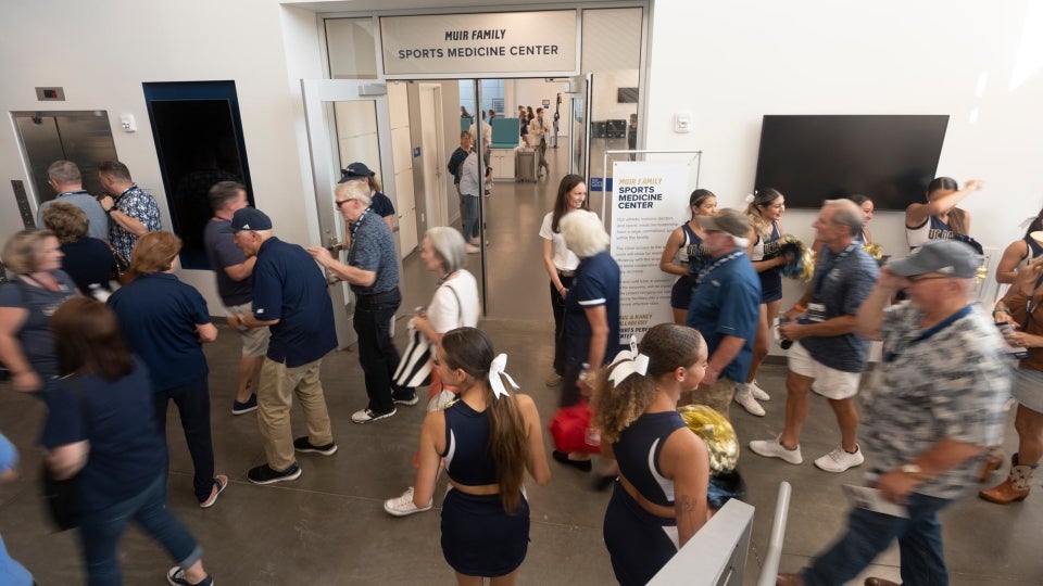 Visitors make their way through the building and its various units, such as the Muir Family Sports Medicine Center. (Gregory Urquiaga/UC Davis)