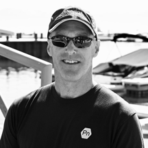 Black and white portrait of Brant Allen wearing sunglasses and a UC Davis Tahoe Environmental Research Center cap.