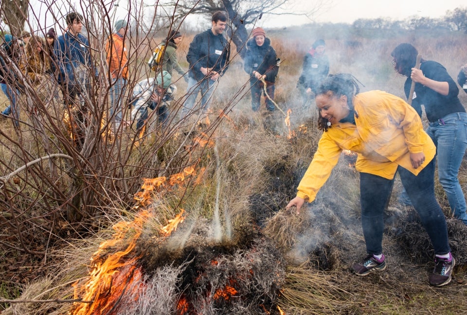 Middleton Manning participates in a Woodland cultural burn with students and community members. Native tribal leaders guide the cultural burning ceremonies.