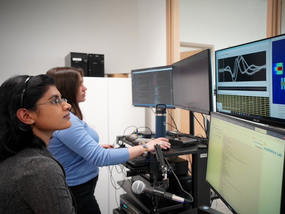 Wairagkar (foreground) researches how to synthesize speech from recorded brain signals.