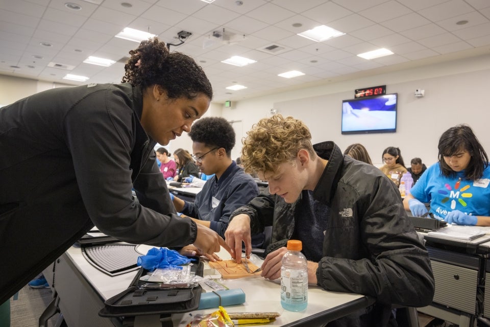 AvenueM students practice their suturing skills during one of the program’s many hands-on teaching sessions.