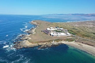 Aerial view of the coastline in Bodega Bay with the Bodega Marine Laboratory visible.