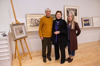 Matt Bult and Maria Bult pose with Maria Manetti Shrem in the center in front of framed artwork.