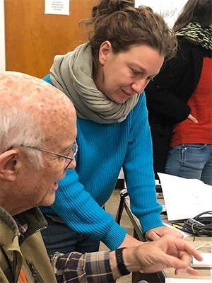 Stiefvater and associate professor of Cooperative Extension Giulia Marino in conversation while examining something placed on a desk.