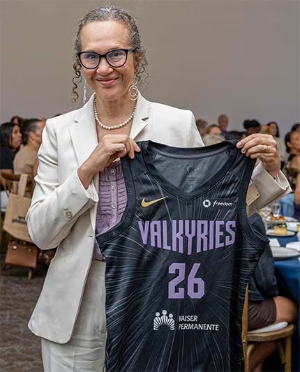 Piri Ackerman holding black "Valkyries 26" jersey
