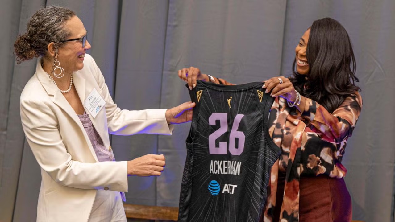 Piri Ackerman receiving a custom Golden State Valkyries jersey from Ay’Anna Moody