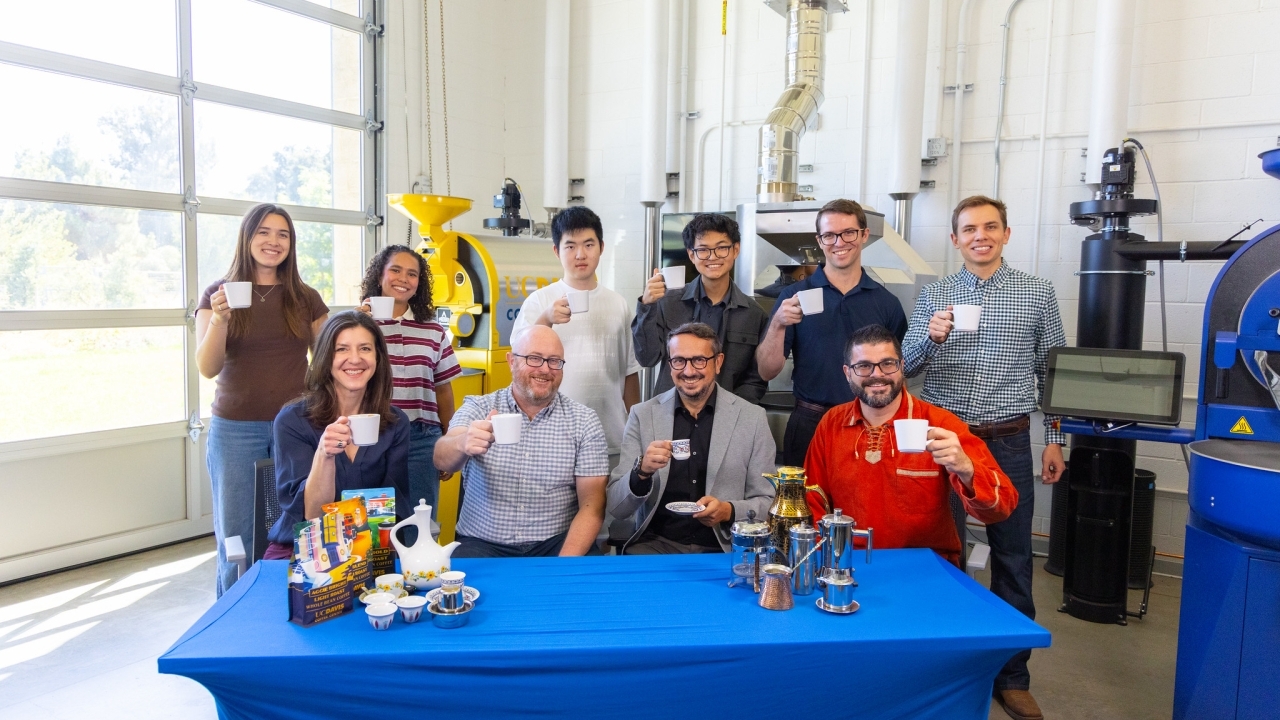 Smiling group photo while enjoying a cup of coffee at the UC Davis Coffee Center.