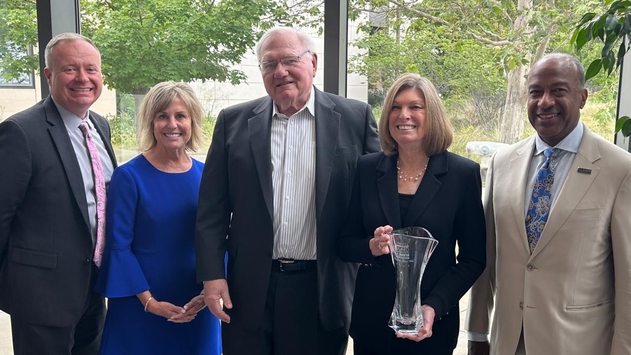 arie West, standing next to her husband, Bruce, holds the Charles J. Soderquist Award. Also pictured, from left: Shaun Keister, vice chancellor, Development and Alumni Relations; Cecelia Sullivan, chair, UC Davis Foundation Board; and Chancellor Gary S. May.