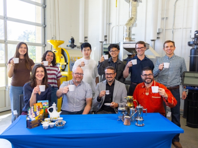 Smiling group photo while enjoying a cup of coffee at the UC Davis Coffee Center.