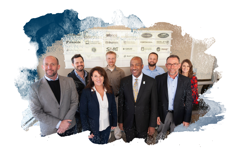 A group of company representatives pose with Chancellor May.