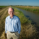 Jay Lund standing in front of a water canal