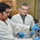 Professor Ilias Tagkopoulos, right, in his laboratory at the UC Davis Genome Center in 2016 with research specialist Navneet Rai. Tagkopoulos, whose work bridges computer science and biology, will lead a new institute for artificial intelligence in food systems supported by the U.S. Department of Agriculture and National Science Foundation. (UC Davis College of Engineering)